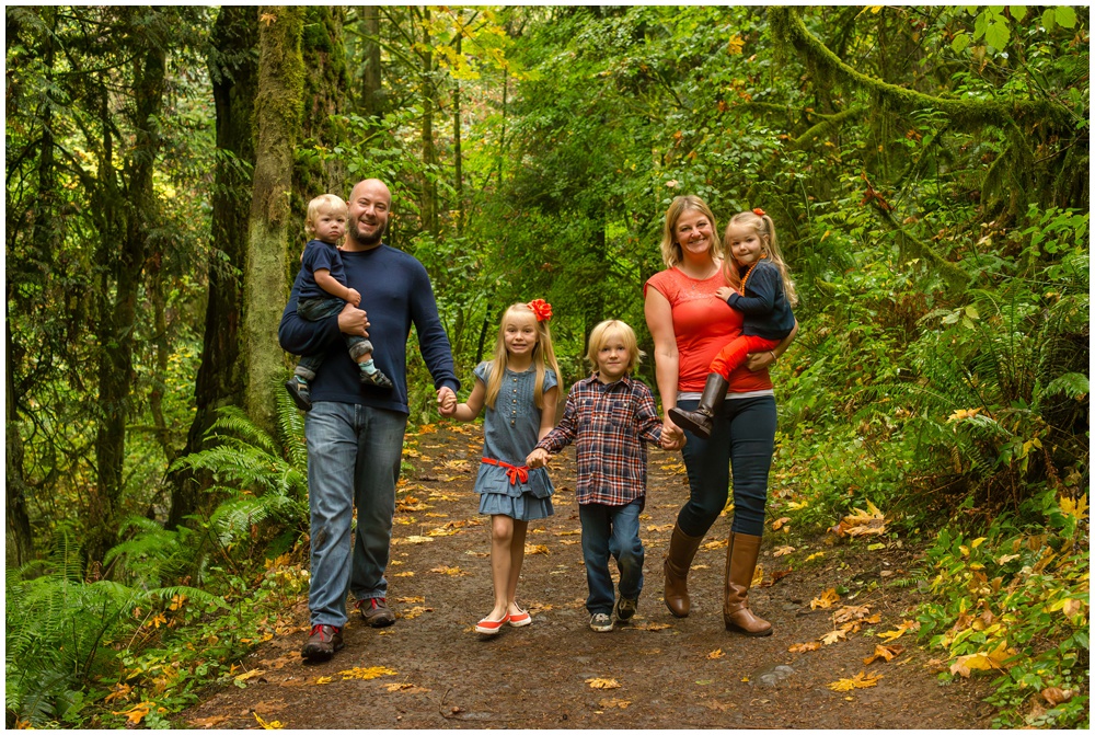 smiling family walking in the woods portland photographer