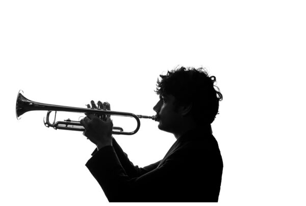 high key silhouette portrait senior boy with trumpet